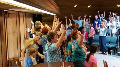 Sanctuary full of people with arms raised