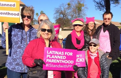 seven people outside holding signs supporting planned parenthood